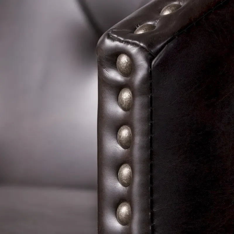 Modern tufted rotating bar stools, adorned with rivets.