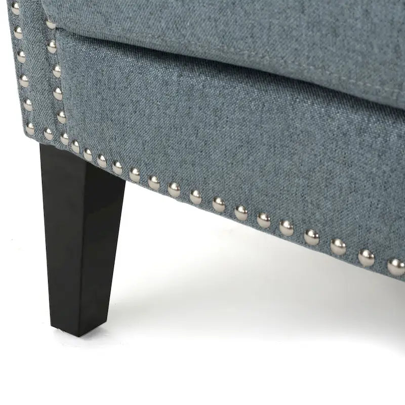 Modern roll-up club chair, adorned with rivet details